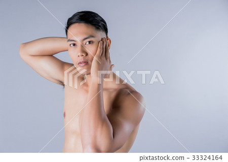 An asian man is posing with nude and strong body on gray background An asian man is posing with nude and strong body on gray background 33324164