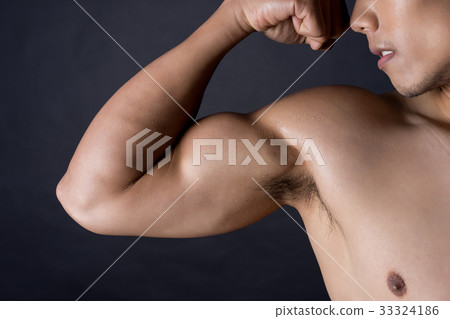 The portrait of a man showing his biceps The portrait of a man showing his biceps 33324186