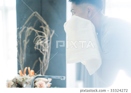 a picture of a man cleaning his face in the bathroom a picture of a man cleaning his face in the bathroom 33324272