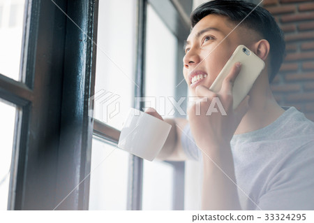 a photo of a man smiling and talking on the phone 33324295