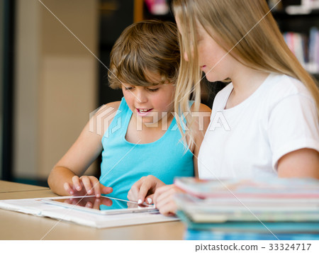 Teenage girl and her brother with books 33324717
