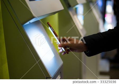 Woman scanning on the payment machine by NFC Woman scanning on the payment machine by NFC 33325036