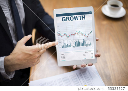 Hands working on digital device network graphic overlay Hands working on digital device network graphic overlay 33325327