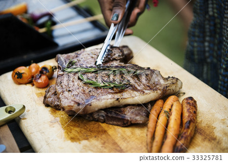 Closeup of homemade grilled food on wooden table summer party Closeup of homemade grilled food on wooden table summer party 33325781