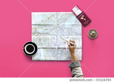 Hand holding toy airplane and planning travel destination Hand holding toy airplane and planning travel destination 33328765