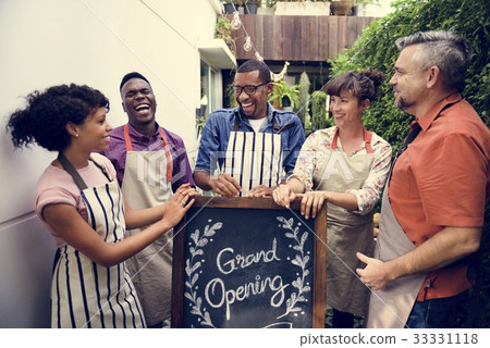 Group of friends with grand opening board together 33331118
