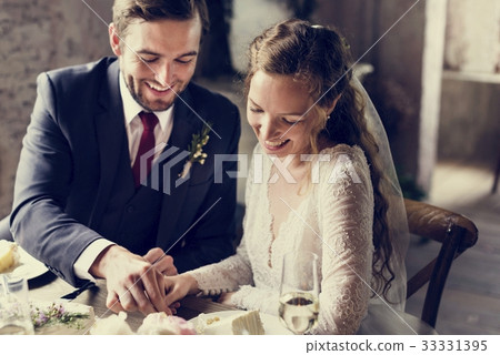 Bride and Groom Cutting Cake on Wedding Reception 33331395