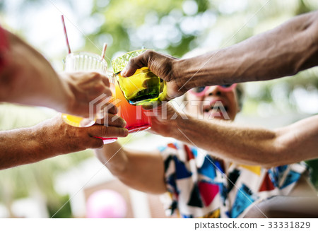 Group of diverse senior adult enjoying beverage by the pool together 33331829