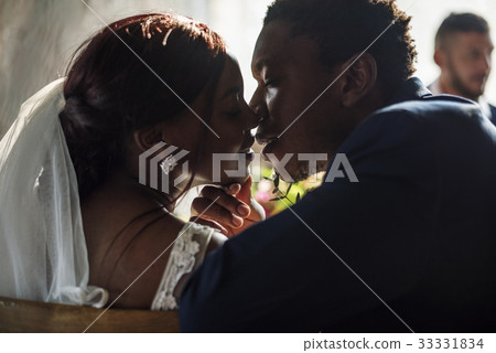 Newlywed African Descent Bride Kissing Groom Wedding Celebration Newlywed African Descent Bride Kissing Groom Wedding Celebration 33331834