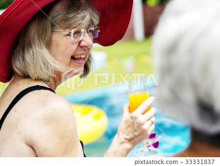 Closeup of senior caucasian woman with juice by the pool Closeup of senior caucasian woman with juice by the pool 33331837