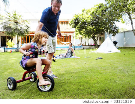 Caucasian father teaching daughter ride the bike Caucasian father teaching daughter ride the bike 33331839