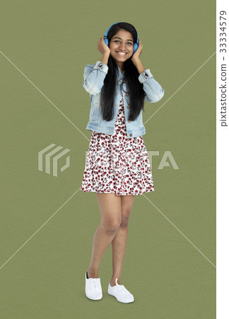 Young indian woman listening music with headphone Young indian woman listening music with headphone 33334579