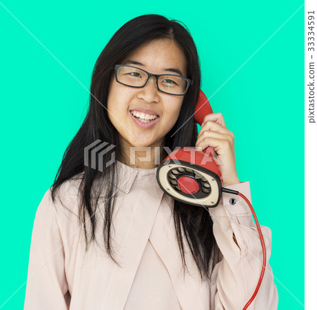 Asian girl talking by phone studio portrait Asian girl talking by phone studio portrait 33334591