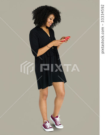 African descent woman using phone African descent woman using phone 33334592