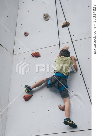 little boy climbing a rock wall outdoor. little boy climbing a rock wall outdoor. 33334828