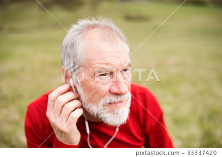 Active senior runner in nature with smart phone Active senior runner in nature with smart phone 33337420