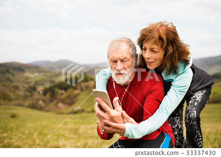 Active senior runners in nature taking photo with Active senior runners in nature taking photo with 33337430