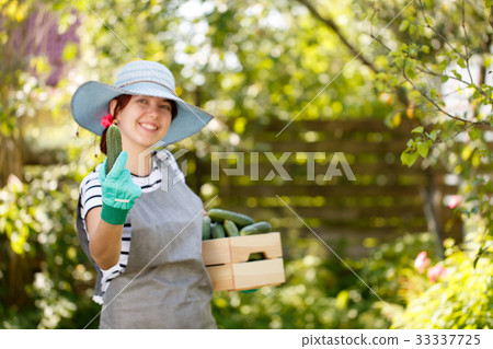 Farmer in hat with cucumber Farmer in hat with cucumber 33337725