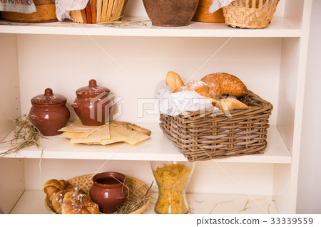 Rack with buns in a wicker box and clay pots Rack with buns in a wicker box and clay pots 33339559