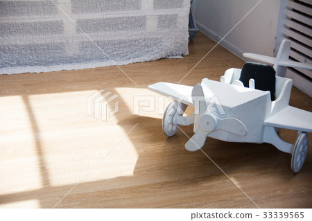 Wooden toy airplane on a wooden floor Wooden toy airplane on a wooden floor 33339565