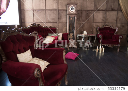 Interior with antique red furniture and clock. 33339579