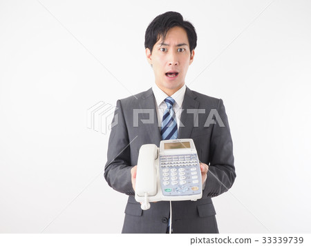 Businessman opening his mouth with a business phone 33339739