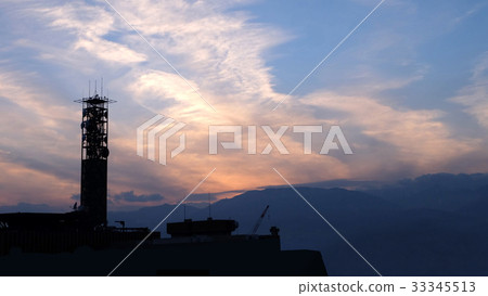 Silhouette of a communication tower in evening sky 33345513