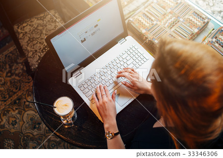 Top view of young female student working on laptop 33346306