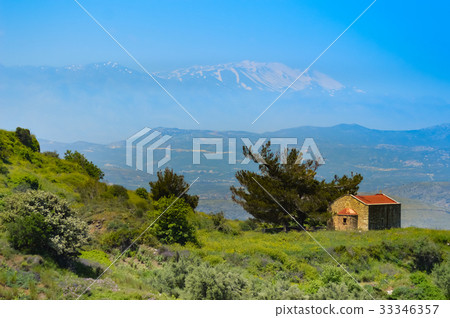 Small chapel on a hill with ida snowy mountain 33346357