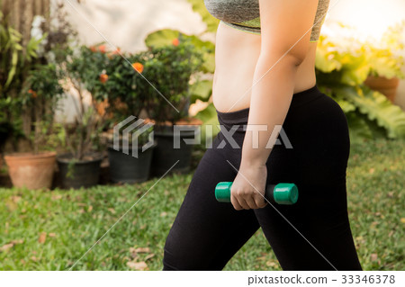 Fat woman weight loss exercise with dumbbell Fat woman weight loss exercise with dumbbell 33346378