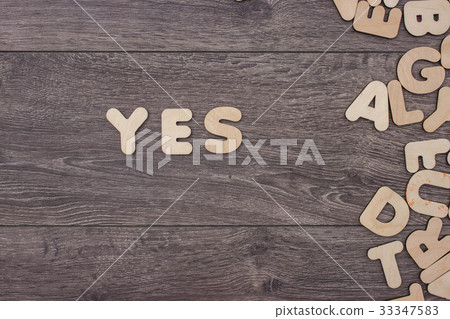 Word made with wooden letters next to a pile of 33347583
