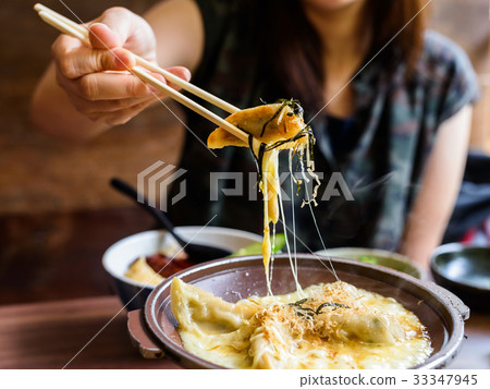 Gyoza with melt cheese took by chopsticks Gyoza with melt cheese took by chopsticks 33347945