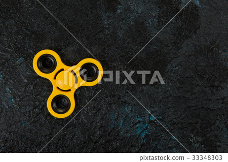 Yellow spinner on a dark Yellow spinner on a dark 33348303