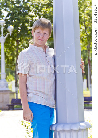 Blond boy near pole in summer Blond boy near pole in summer 33348917