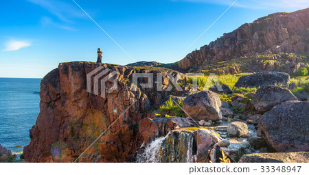 Girl in a dress on the edge of a cliff 33348947