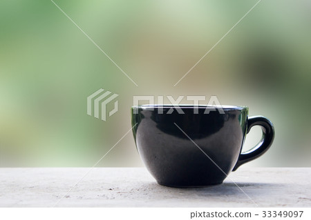 Black cup of coffee or tea on table 33349097