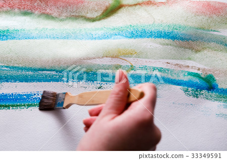 Brush in hands. Artist creating watercolor Brush in hands. Artist creating watercolor 33349591