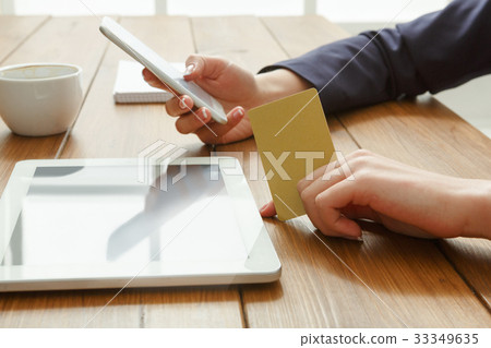 Woman's using phone for payment with credit card 33349635