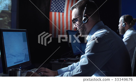 Man working at laptop in space center 33349676