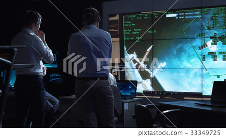 People working in mission control center 33349725