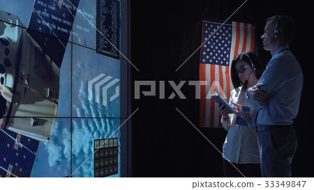 People communicating in space flight center 33349847