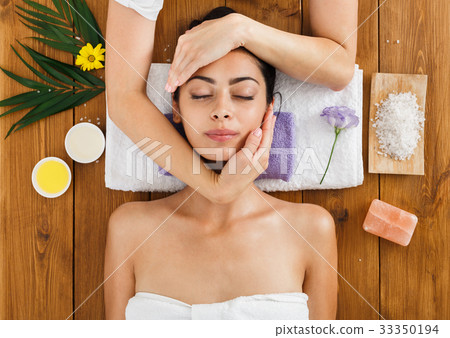 Woman massagist make face lifting massage in spa Woman massagist make face lifting massage in spa 33350194