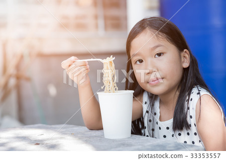 cute asian kid girl eating instand noodle cup, 33353557