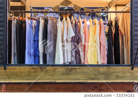 female clothes on open cloth rail wooden hanger female clothes on open cloth rail wooden hanger 33354181