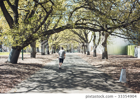 Cool skater manl riding a long board at the park 33354904