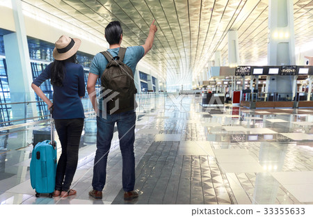 Excited asian couple traveler pointing with hand 33355633