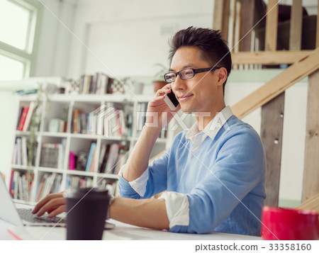 Portrait of young businessman with mobile 33358160