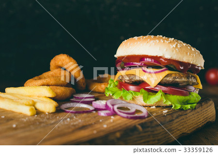 Cheeseburger, french fries and onion rings. Fast 33359126