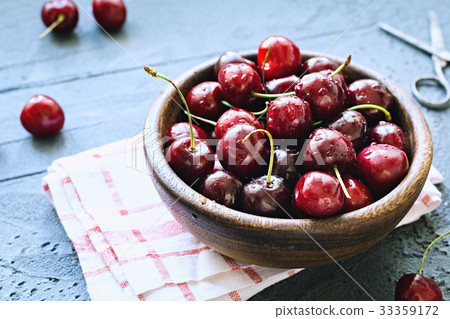 Bowl of fresh red cherries on blue background Bowl of fresh red cherries on blue background 33359172