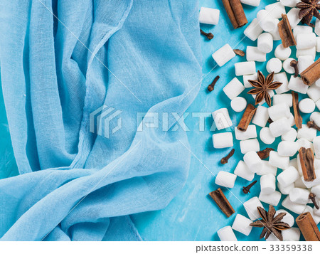 Marshmallows and winter spices on blue background 33359338